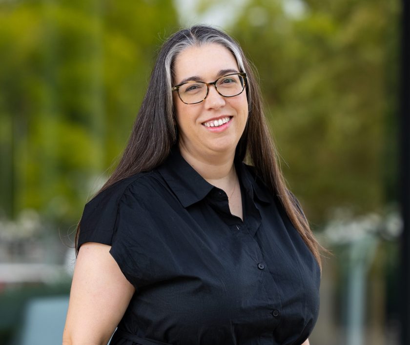 headshot of woman wearing a black dress
